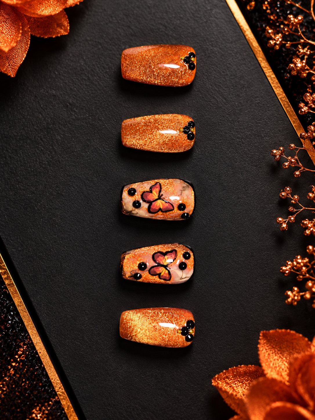Copper cat-eye press-ons with painted monarch butterflies