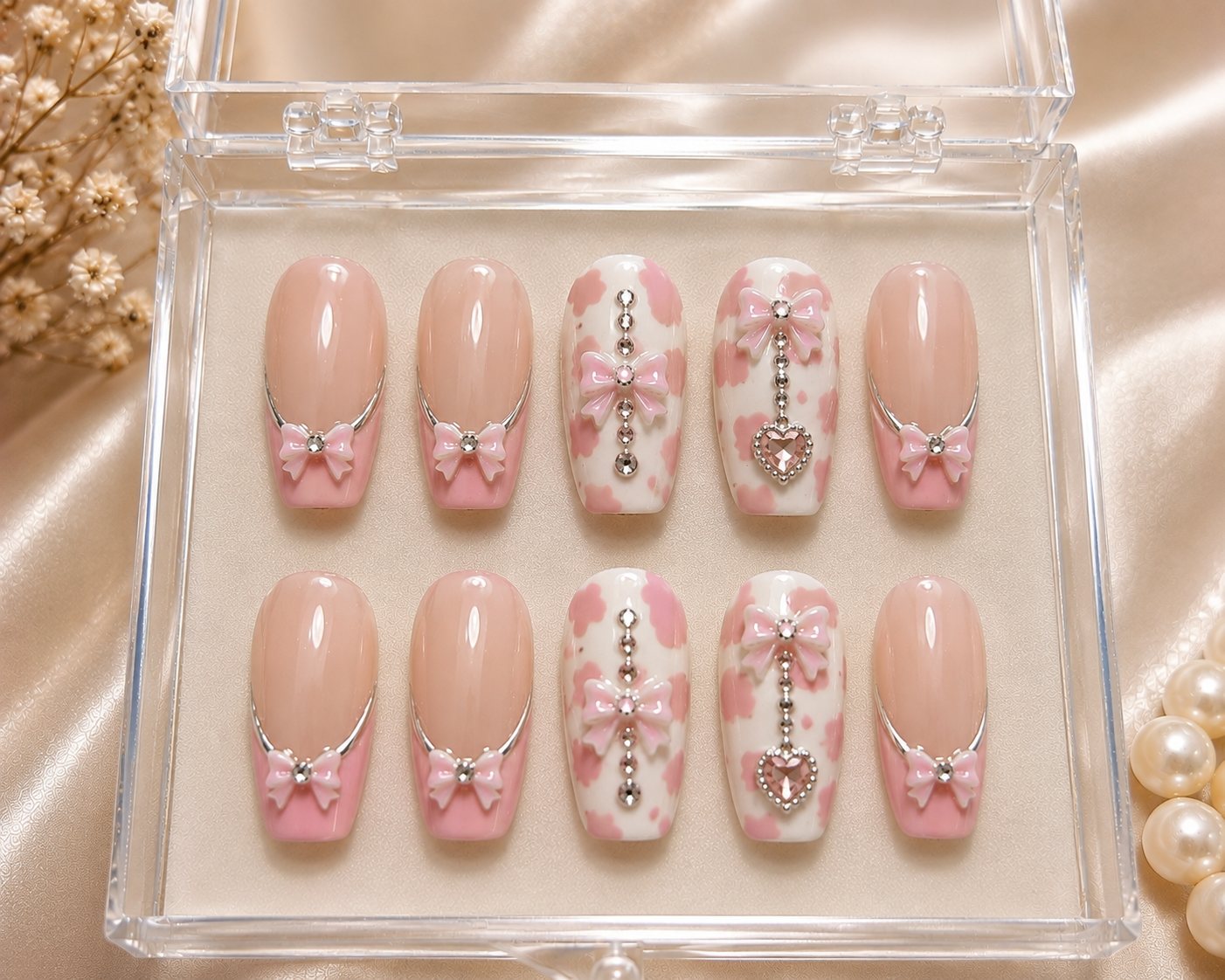 Pink press-on nails with bow charms